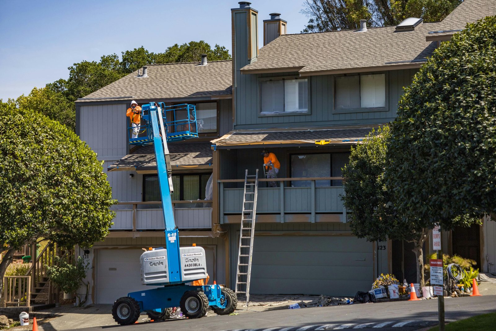 Roof replacement crew with lift on a townhome